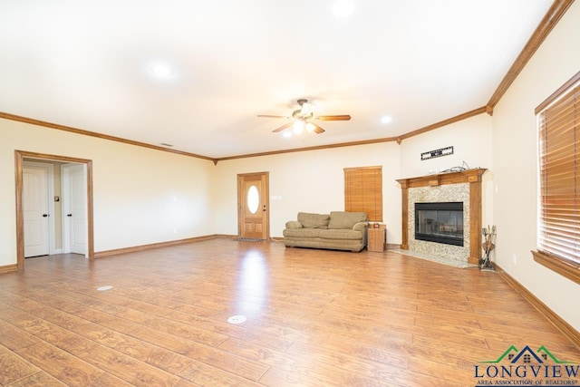 unfurnished living room featuring light hardwood / wood-style floors, ceiling fan, and ornamental molding