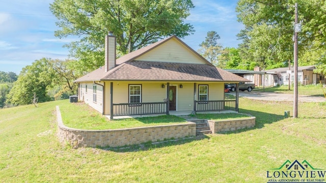 view of front of house with central AC unit, a porch, and a front lawn