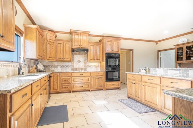 kitchen featuring backsplash, light stone countertops, black double oven, and ornamental molding