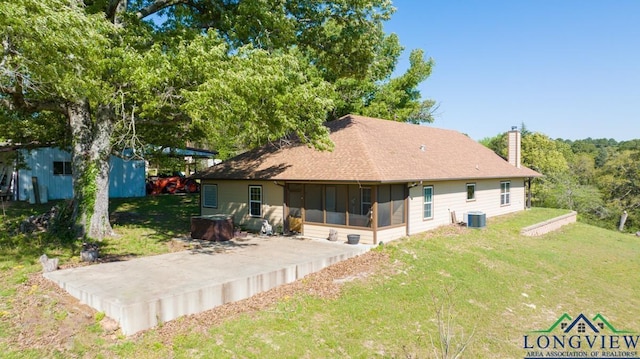 back of house featuring central AC unit, a sunroom, a yard, and a patio