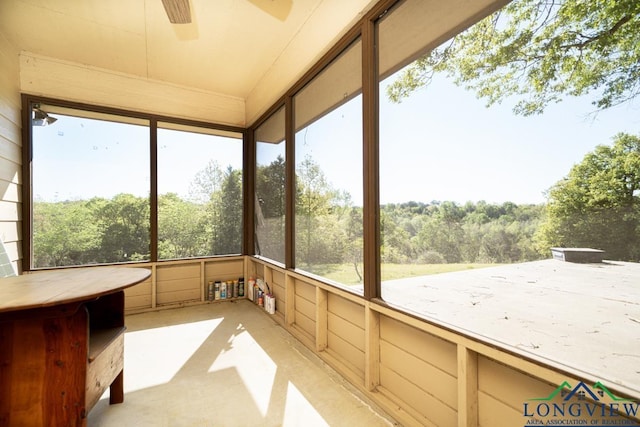 unfurnished sunroom with ceiling fan