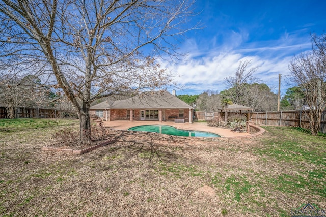 view of yard featuring a fenced in pool, a fenced backyard, and a patio