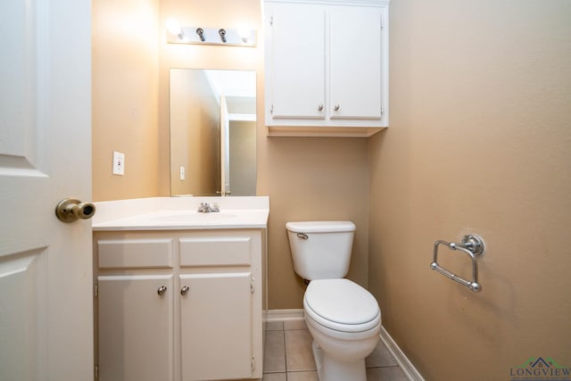 bathroom featuring baseboards, vanity, toilet, and tile patterned floors