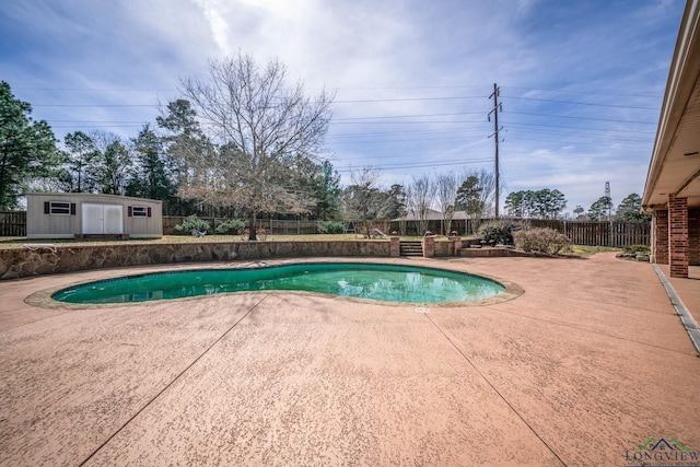 view of pool featuring an outbuilding, a patio area, a fenced backyard, and a fenced in pool