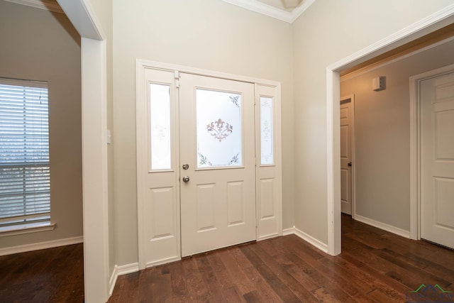 entrance foyer with crown molding, dark wood finished floors, and baseboards