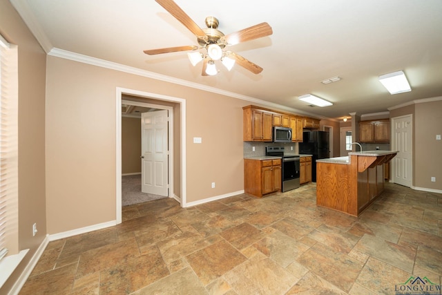 kitchen featuring brown cabinets, baseboards, stainless steel appliances, and a kitchen breakfast bar