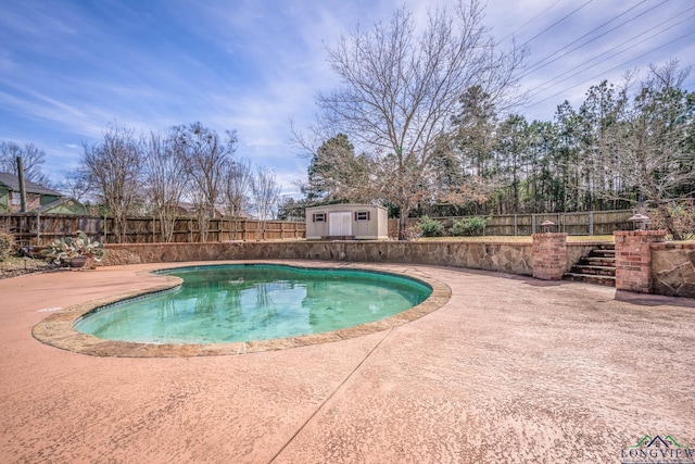 view of pool featuring a fenced in pool, a patio, a fenced backyard, an outdoor structure, and a shed