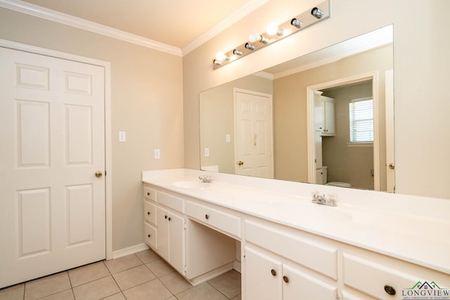 bathroom with tile patterned flooring, toilet, a sink, ornamental molding, and double vanity