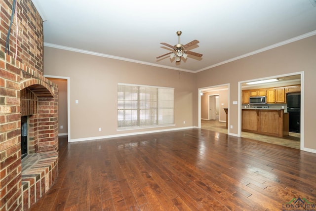 unfurnished living room with hardwood / wood-style flooring, a fireplace, and baseboards