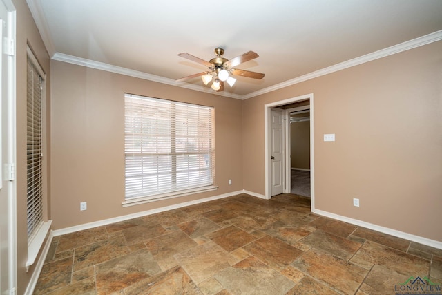 empty room with ornamental molding, stone tile flooring, ceiling fan, and baseboards