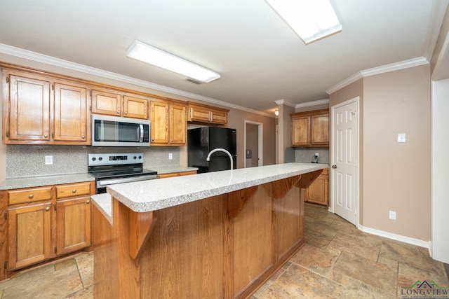 kitchen with stainless steel appliances, stone tile flooring, light countertops, and visible vents