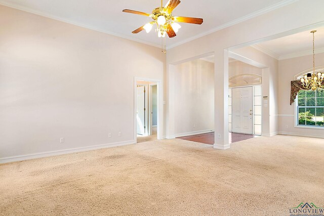 unfurnished room featuring carpet flooring, ceiling fan with notable chandelier, and ornamental molding