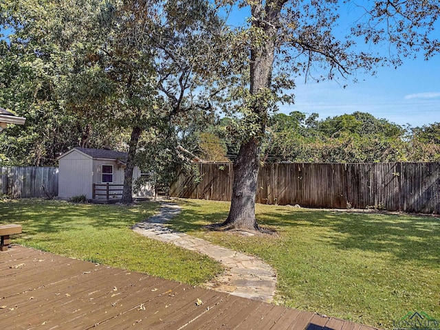 view of yard featuring a shed and a wooden deck