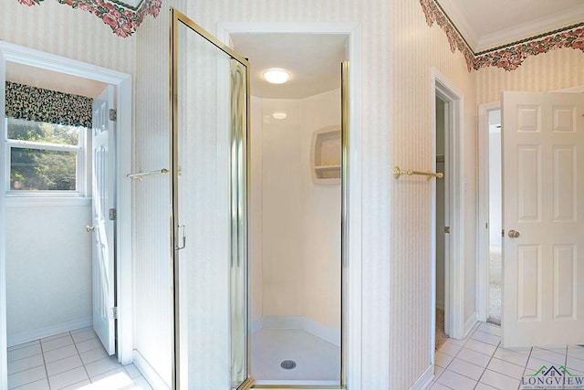 bathroom featuring tile patterned floors, a shower with shower door, and ornamental molding