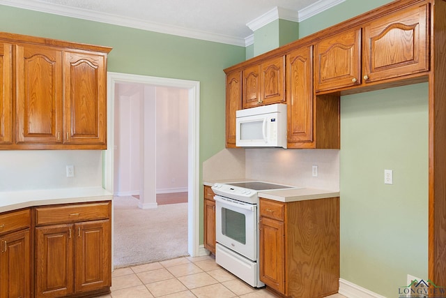 kitchen featuring white appliances, crown molding, and light tile patterned floors