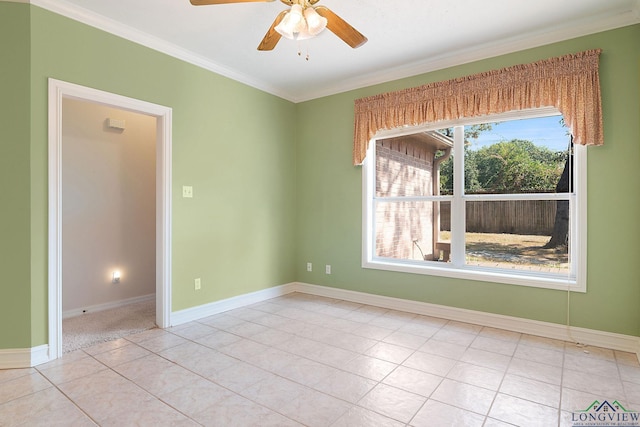 tiled empty room with ceiling fan and ornamental molding