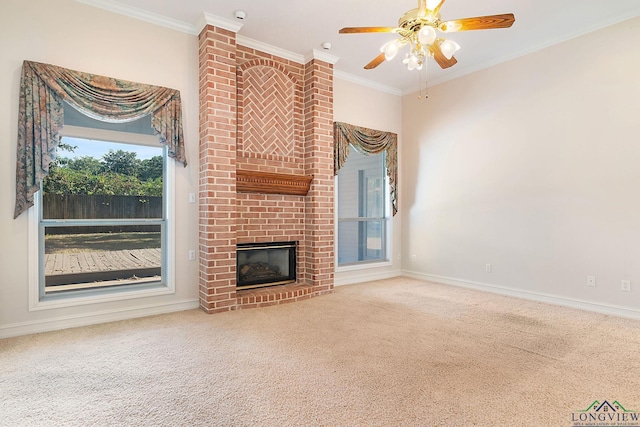 unfurnished living room featuring a brick fireplace, ceiling fan, carpet, and ornamental molding