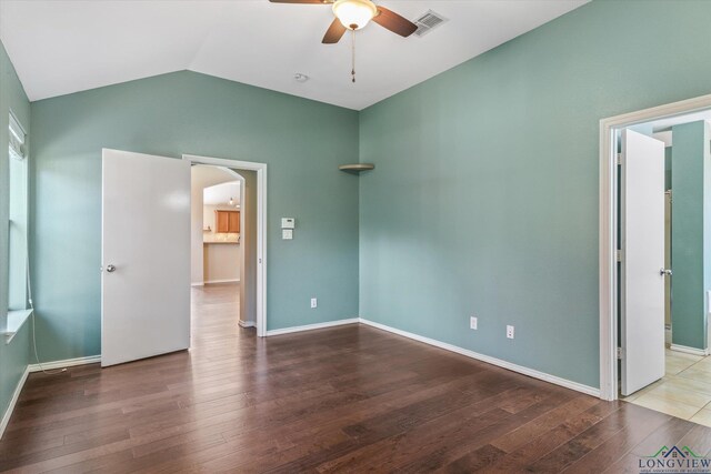 unfurnished bedroom with hardwood / wood-style floors, ceiling fan, and lofted ceiling