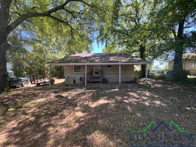 back of property featuring a carport