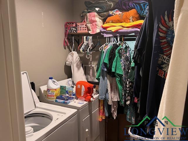 clothes washing area featuring washing machine and clothes dryer and laundry area