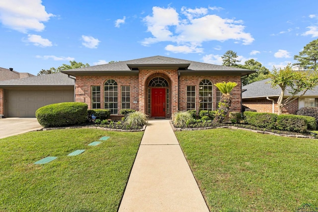 view of front of property with a front lawn, roof with shingles, brick siding, an attached garage, and driveway