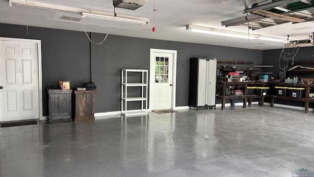garage featuring baseboards and a garage door opener