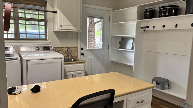 laundry room featuring plenty of natural light, cabinet space, a sink, and independent washer and dryer