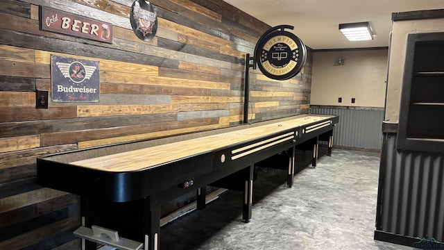 interior space featuring wainscoting and wood walls