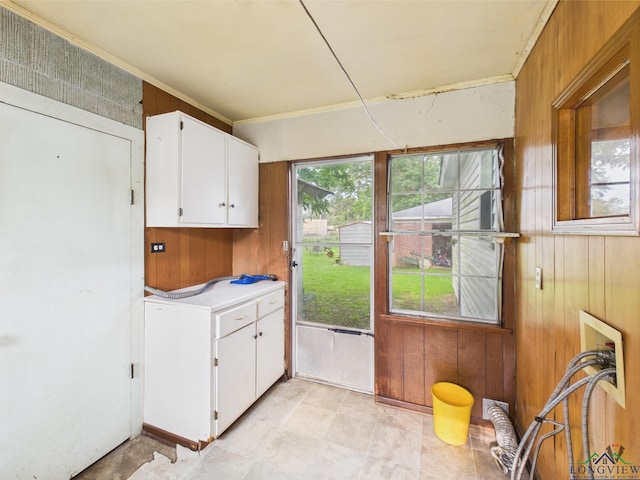 411 W Harrison St, Jefferson, TX 75657 - washroom featuring cabinet space, wooden walls, and ornamental molding
