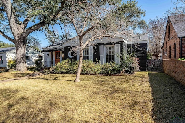 rear view of property with a yard