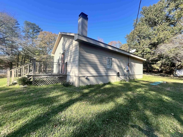 view of home's exterior featuring a yard and a wooden deck