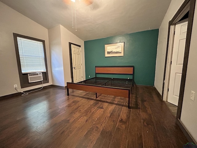 unfurnished bedroom featuring dark hardwood / wood-style floors, cooling unit, and lofted ceiling