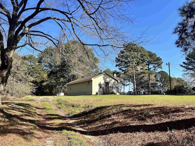 view of side of property with a lawn