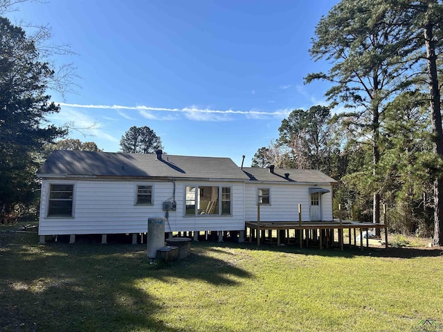 rear view of property featuring a yard