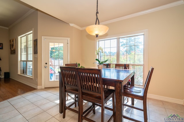 dining space featuring light tile patterned floors and ornamental molding