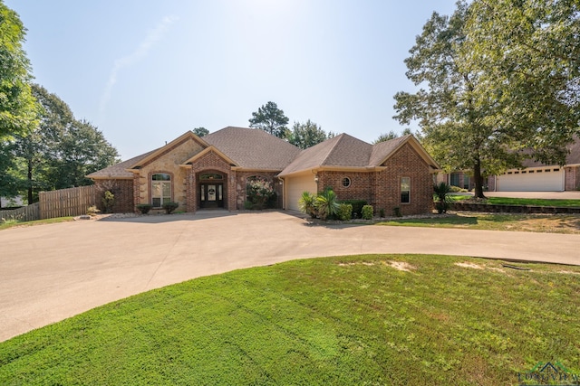 view of front facade featuring a front lawn and a garage