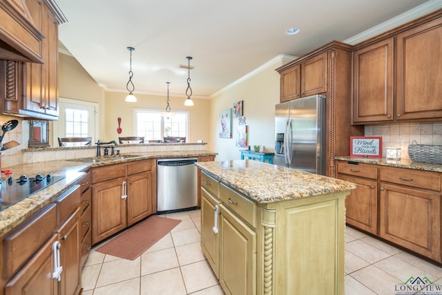 kitchen with sink, hanging light fixtures, a kitchen island, light tile patterned flooring, and appliances with stainless steel finishes