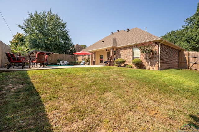 view of yard with a fenced in pool and a patio