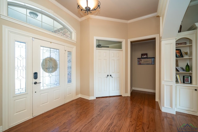 foyer entrance featuring crown molding and dark wood-type flooring