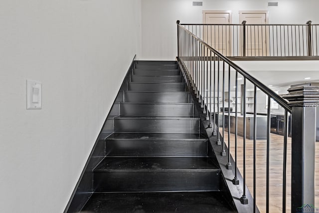 stairs with hardwood / wood-style flooring