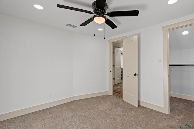 unfurnished bedroom with ceiling fan and carpet floors