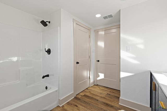 bathroom featuring vanity,  shower combination, and hardwood / wood-style flooring