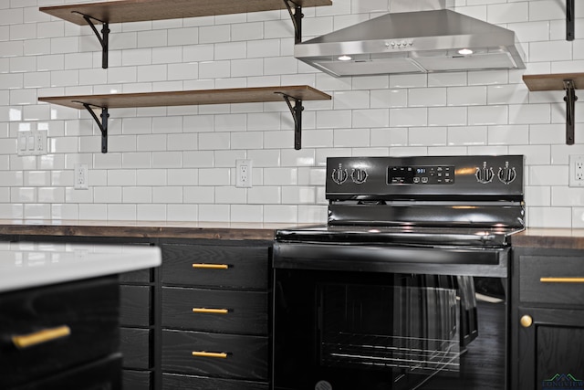 kitchen featuring decorative backsplash, black electric range oven, and wall chimney range hood