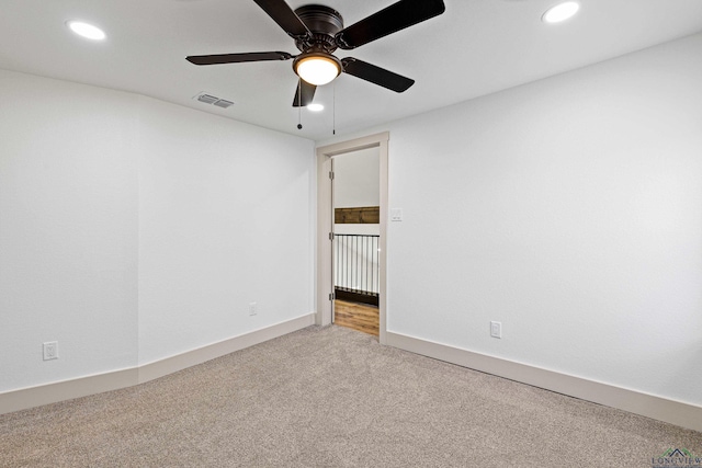 empty room featuring carpet floors and ceiling fan