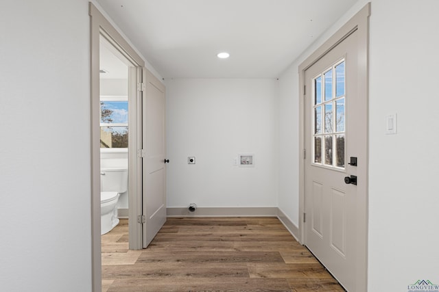 laundry area with hookup for an electric dryer, hookup for a washing machine, and hardwood / wood-style floors