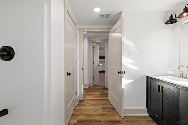 bathroom with hardwood / wood-style flooring and vanity