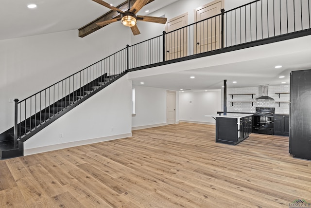 unfurnished living room with beamed ceiling, high vaulted ceiling, light hardwood / wood-style flooring, and ceiling fan