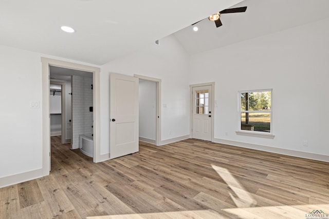 interior space with ceiling fan, light hardwood / wood-style floors, and high vaulted ceiling