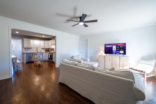 living room with dark hardwood / wood-style flooring, ornamental molding, and ceiling fan