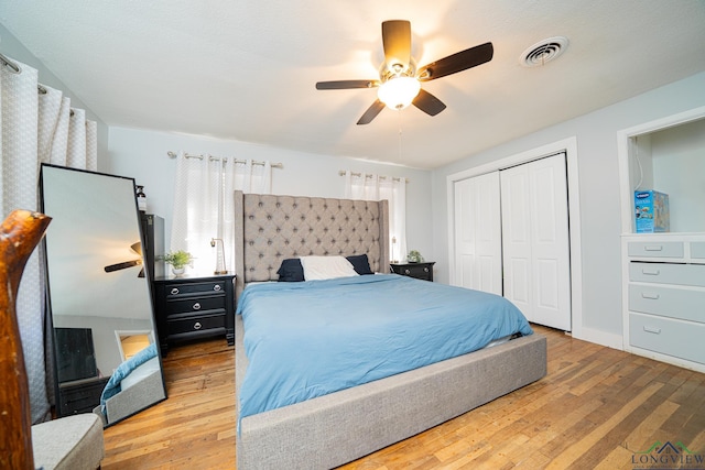 bedroom with ceiling fan, hardwood / wood-style flooring, and a closet